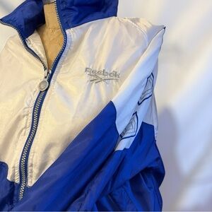 Reebok Windbreaker: Blue + White with diamond embroidery. Size small.